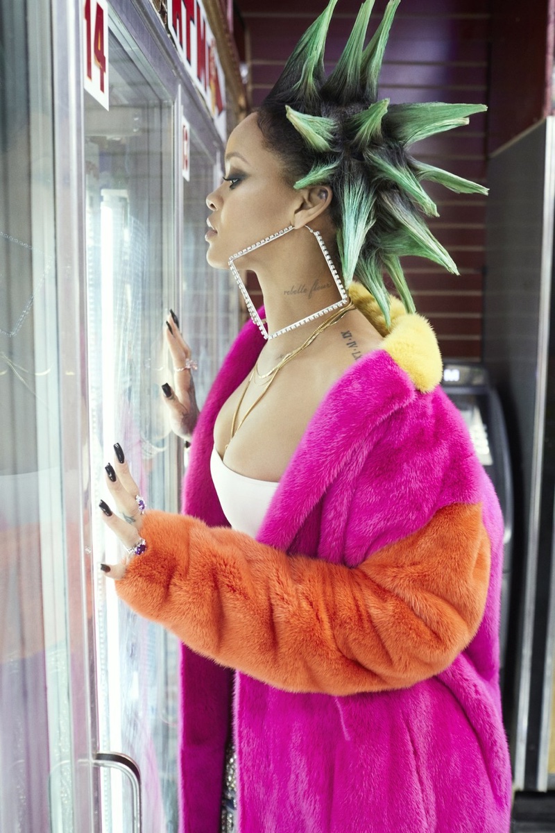 Wearing her hair in green spikes, Rihanna poses in Bally coat, Reiss shirt and DSquared2 jeans