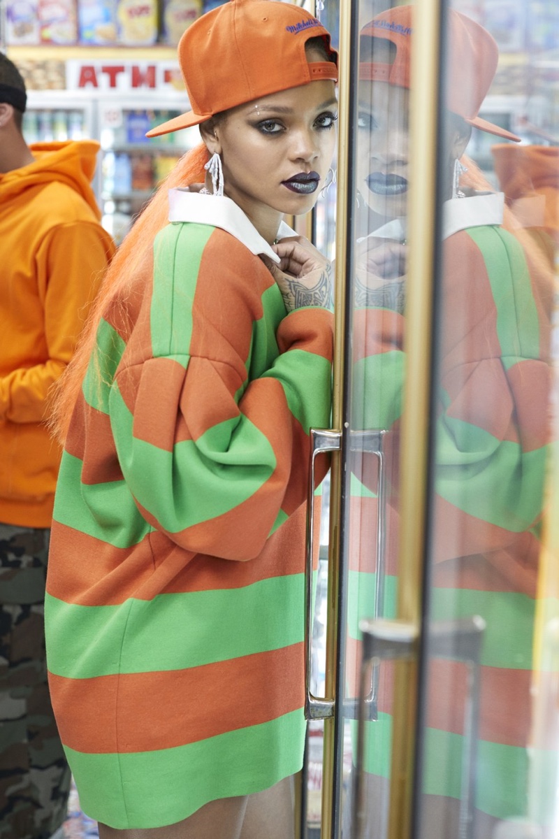 Embracing stripes, Rihanna wears Marc Jacobs shirt, Mitchell & Ness hat and My Enemy by Chris Habana x Shannon Stokes earrings