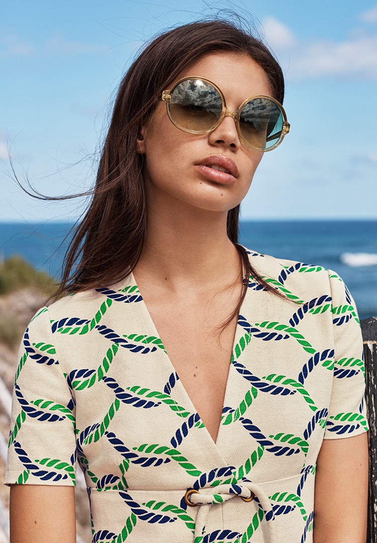 Model Sara Sampaio wears Tory Burch Pier Dress and Oversize Round Sunglasses