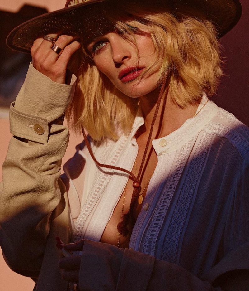 Wearing a hat, Edita Vilkevicute models Oscar de la Renta dress and Bottega Veneta trench coat