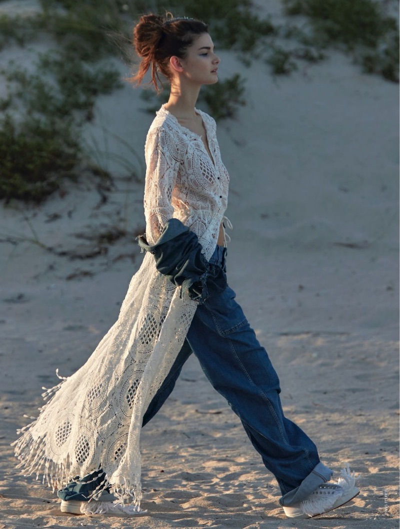 Model Ophelie Guillermand wears Raffaela D’Angelo crochet top with fringe and Stella McCartney jeans