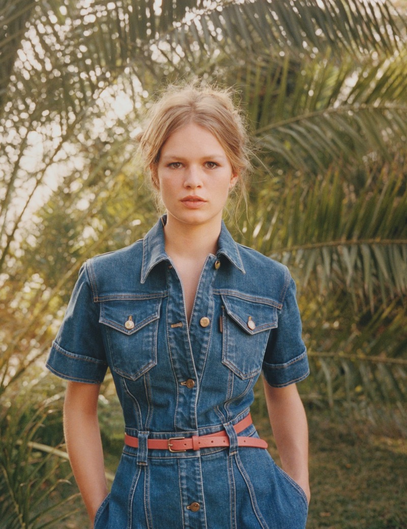 Model Anna Ewers poses in Louis Vuitton denim dress and J. Crew belt