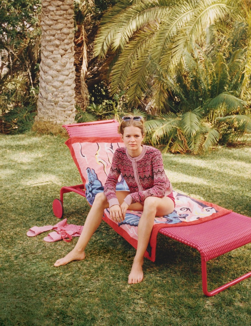 Posing outdoors, Anna Ewers models Alberta Ferretti cardigan, Hesperios bikini bottom, Miu Miu  sunglasses and sandals