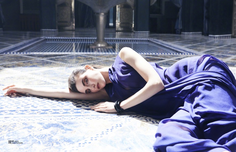 Lounging in the sun, Jacquelyn Jablonski models Lanvin dress with Lizzie Fortunato jewelry