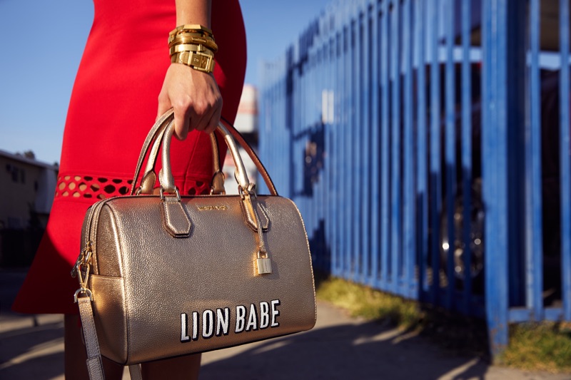 Singer Jillian Hervey poses with customized Michael Kors Mercer duffle bag