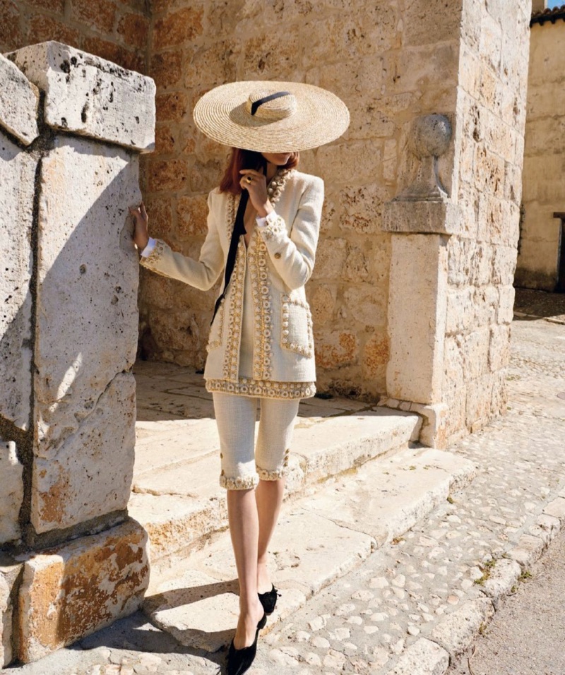 Covering up, Kati Nescher models Chanel tweed jacket and pants with Manolo Blahnik flats