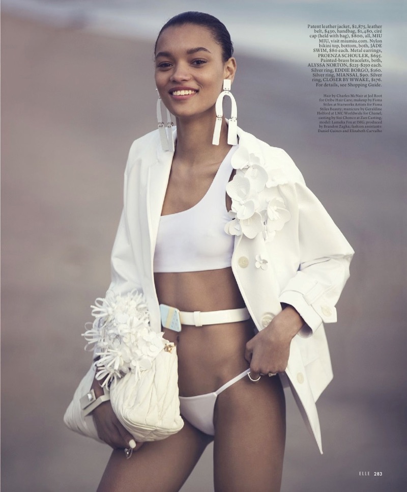 Flashing a smile, Lameka Fox wears Miu Miu leather jacket, belt, cap and handbag. Bikini bottoms from Jade Swim.