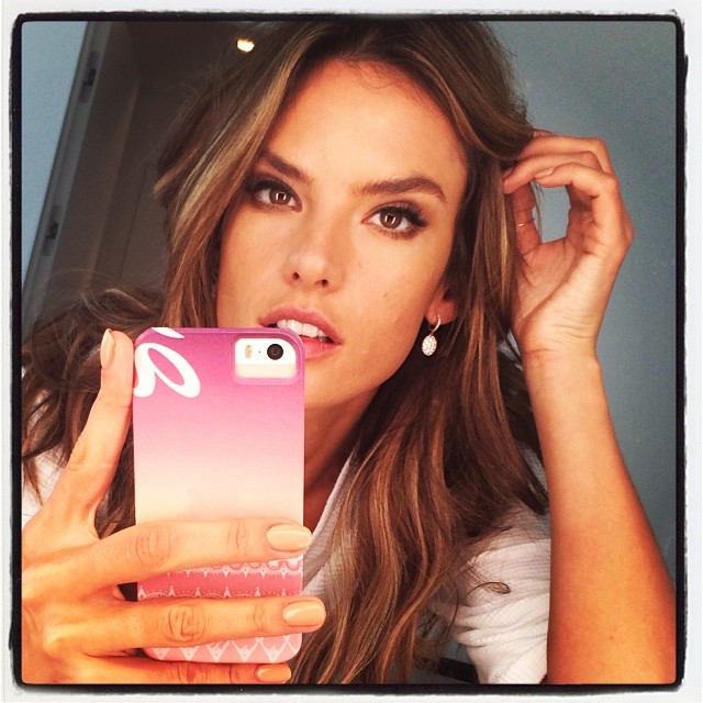 WORK THE MIRROR: Brazilian model Alessandra Ambrosio takes a selfie while flashing her phone cover in the mirror. Take it back to days of MySpace.  