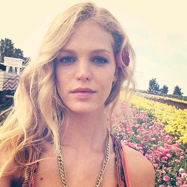 Erin Heatherton is surrounded by colorful flowers