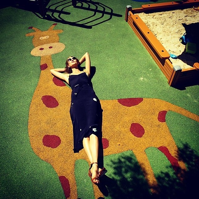 Karlie Kloss poses on a giraffe which Derek Blasberg took a photo of