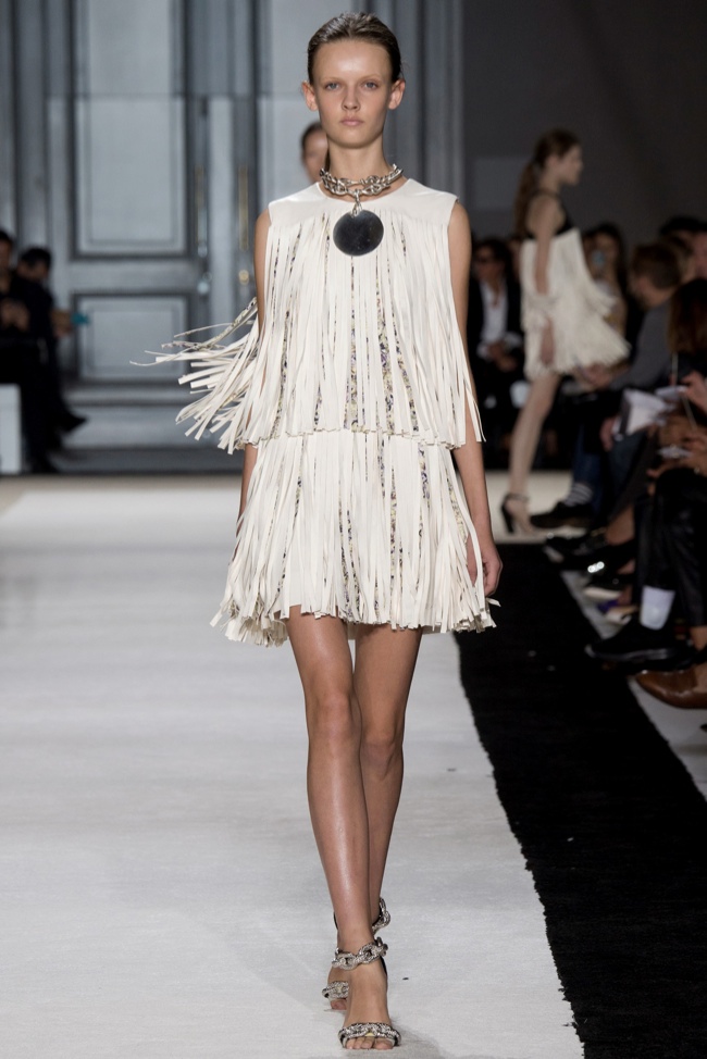 A model wears a fringe-adorned dress for Giambattista Valli's 1970s inspired spring 2015 collection. 