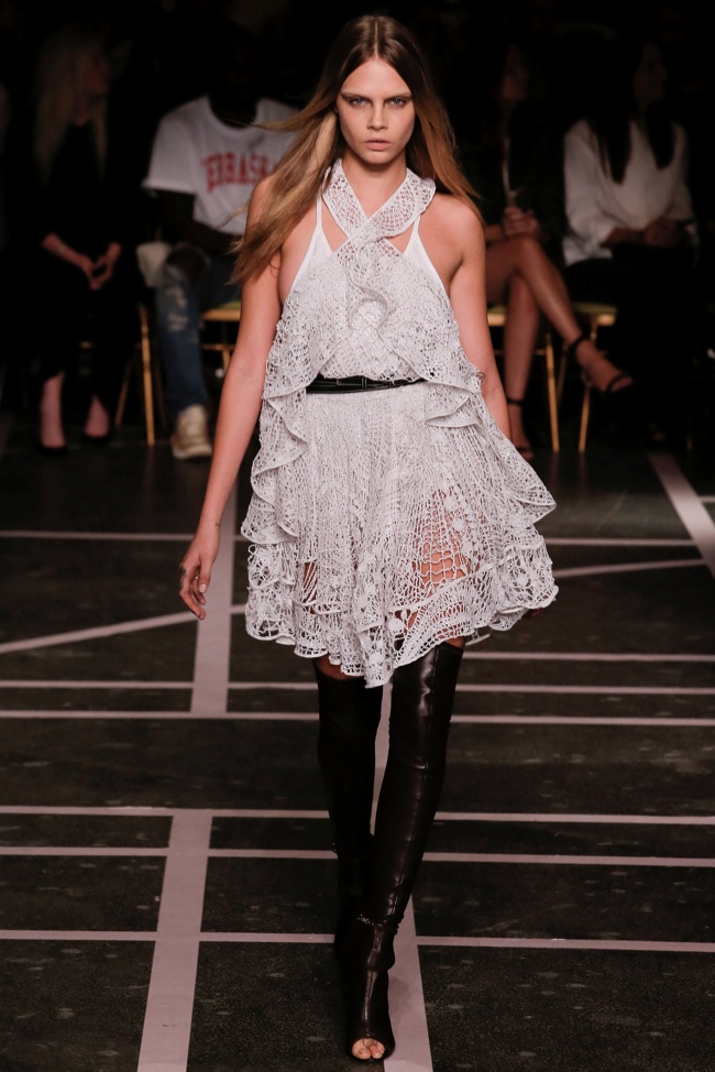 Cara Delevingne wears a white lace dress from Givenchy's spring-summer 2015 collection.