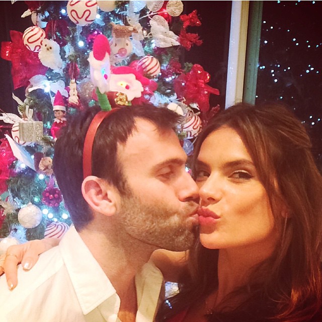 Alessandra Ambrosio shares a holiday themed kiss