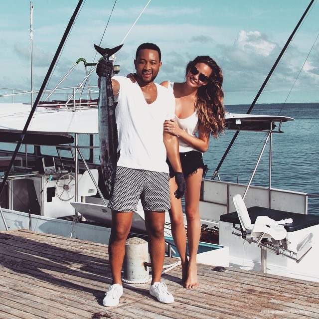 John Legend & Chrissy Teigen with a big fish they caught