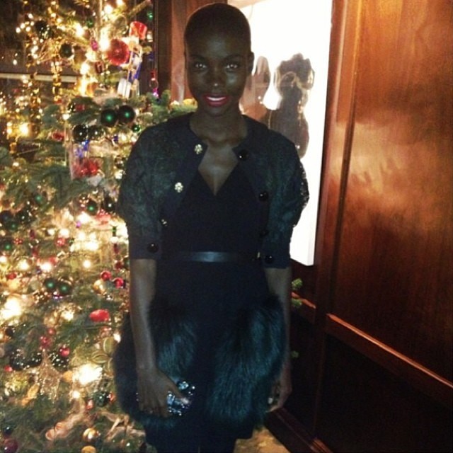 Jeneil Williams poses near a Christmas tree