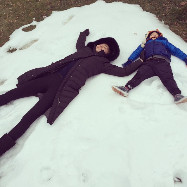 Miranda Kerr and her son Flynn make snow angels