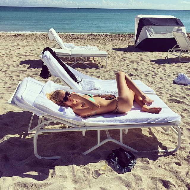 Toni Garrn lounges on the beach