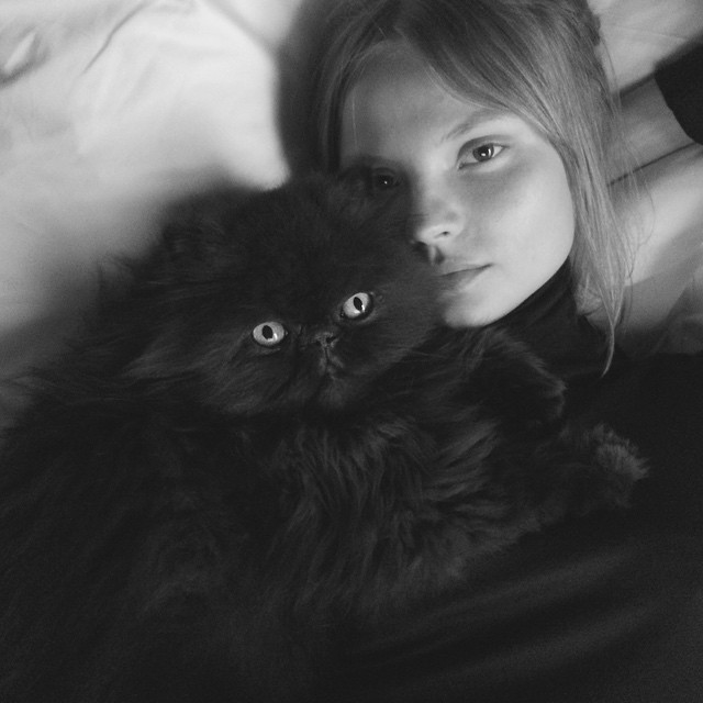 Magdalena Frackowiak poses with a black cat