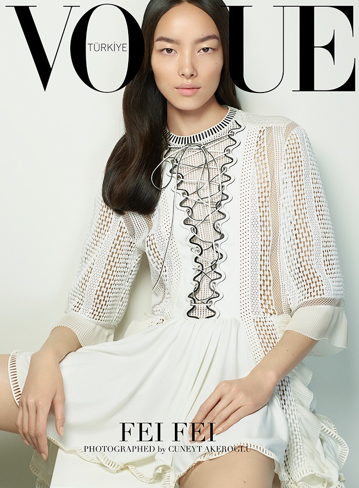 Fei Fei Sun models a white dress from Louis Vuitton's spring collection on her cover