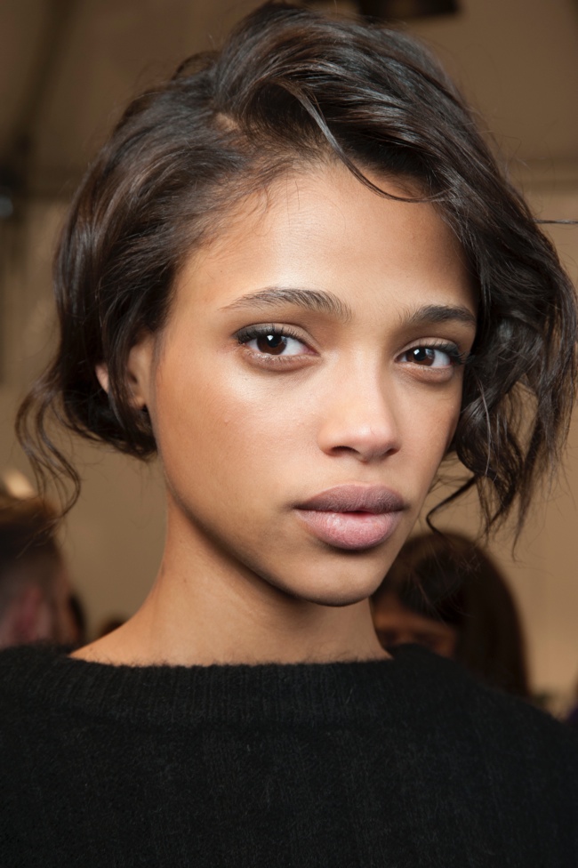 Aya Jones wears a messy hairstyle with pink lips