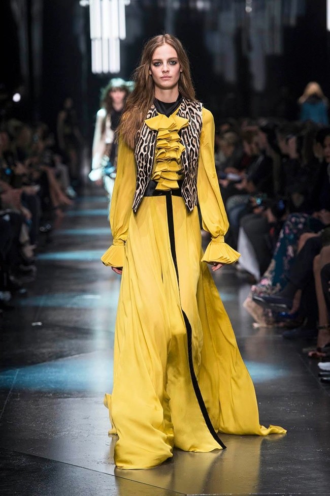 Model wears yellow gown with ruffles at Roberto Cavalli's fall-winter 2015 show