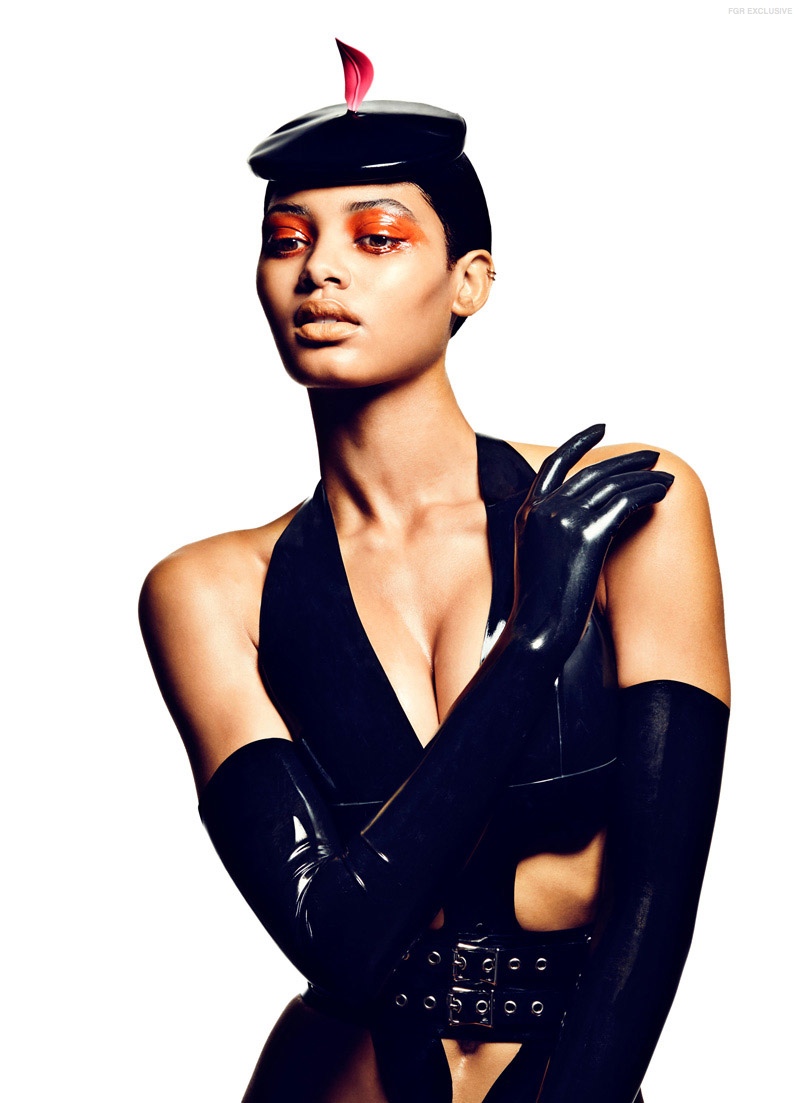An all black look including gloves features a pop of orange and red. 