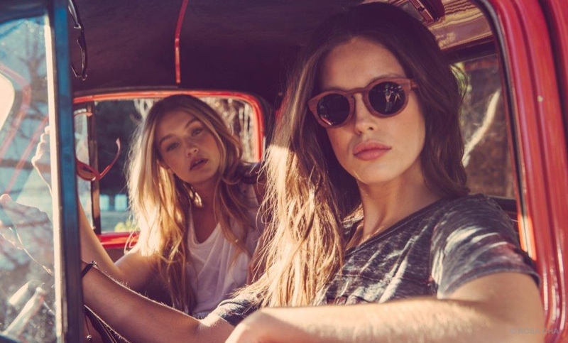 Emily DiDonato & Gigi Hadid pose in a pick-up truck. 