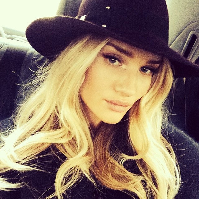 Donning a wide-brimmed hat, Rosie takes a stylish Instagram selfie. 