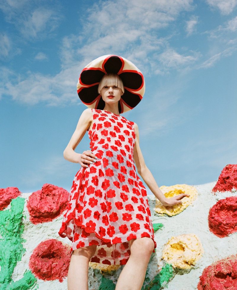 This dramatic shot features model Nora posing at the famous art installation in a red, spot adorned dress