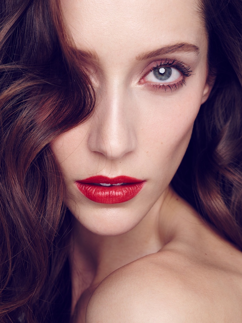 Alana wears a fiery red lip in this image