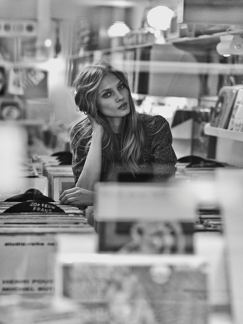 Anna poses in a record store in this black and white image