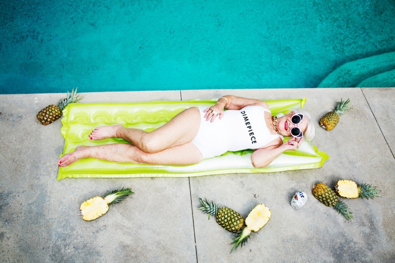 Posing poolside, Winkle keeps it chill with pineapples and a can of Bud Light