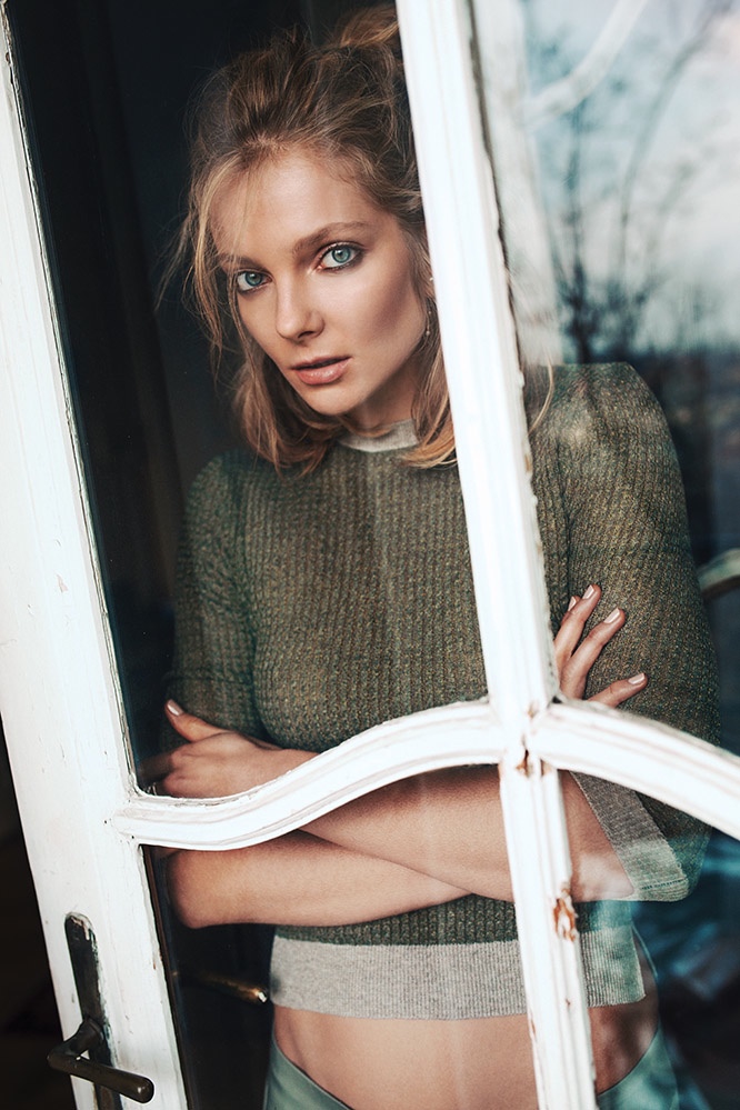 Eniko models a green sweater