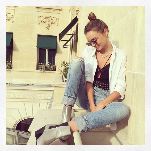 The Australian model keeps it casual in ripped denim with a white shirt and black tank. Photo via Instagram. 