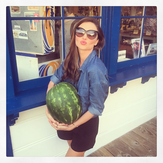 Miranda Kerr carries a watermelon with a denim, long-sleeved shirt. Photo via Instagram. 
