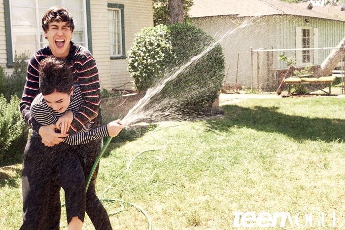 Charli and Nat play with a water hose