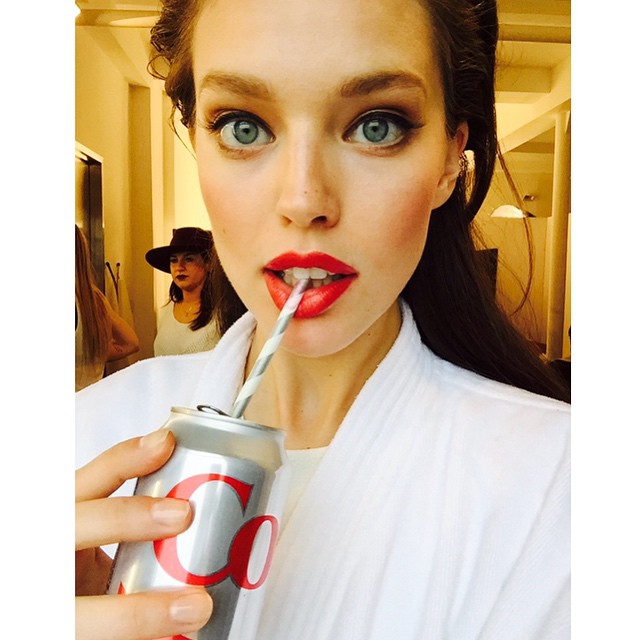 Emily DiDonato rocks a red lip on set of Maybelline. Photo via Instagram. 