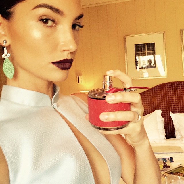 Lily Aldridge looks chic with a dark lip and green earrings before the Met Gala
