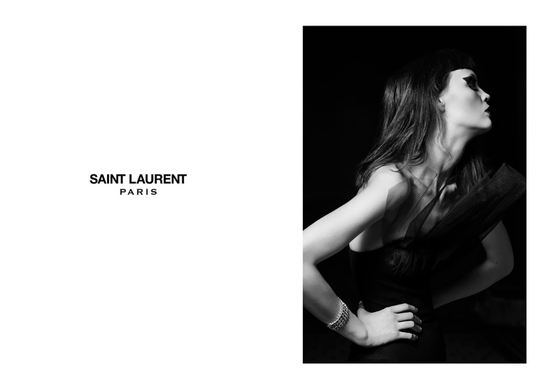 The dark-haired model wears Saint Laurent evening dress