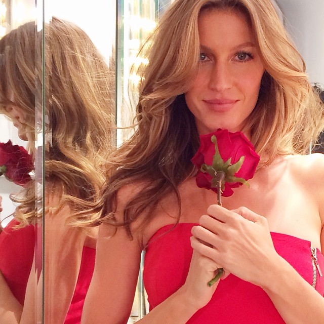 Gisele Bundchen stuns as she holds a red rose. Photo via Instagram.