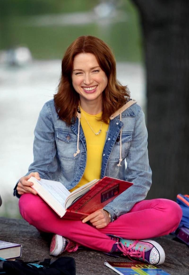 Kimmy Schmidt (Ellie Kemper) wears a denim jacket over a yellow top and pink pants. Photo: Netflix