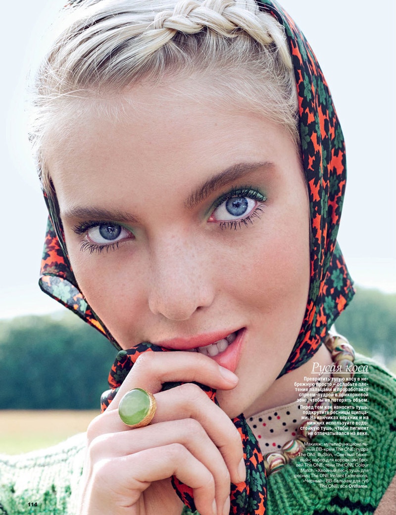 The model wears colorful scarves over her hair