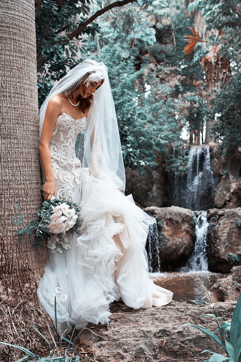 A traditional veil and elegant bouquet serve as the ultimate bridal accessories
