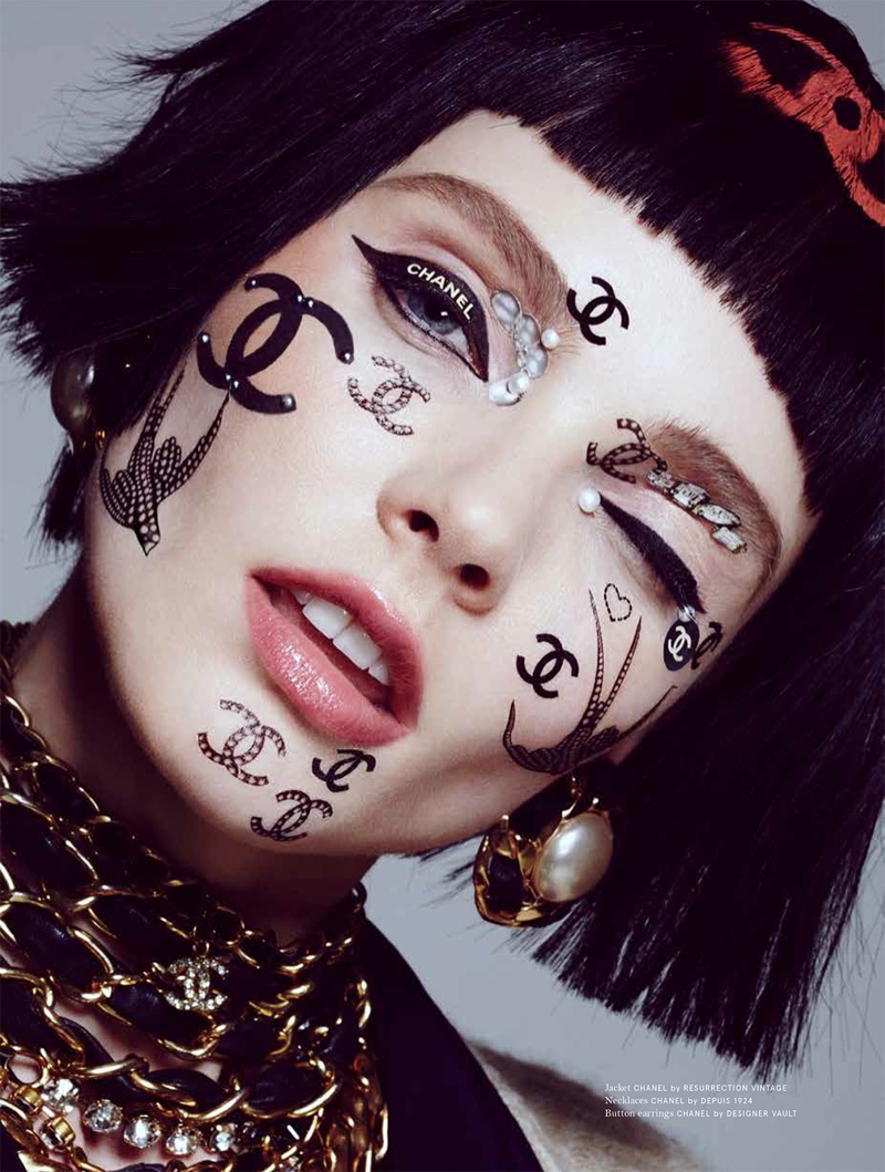 The model poses with Chanel logos covering her face