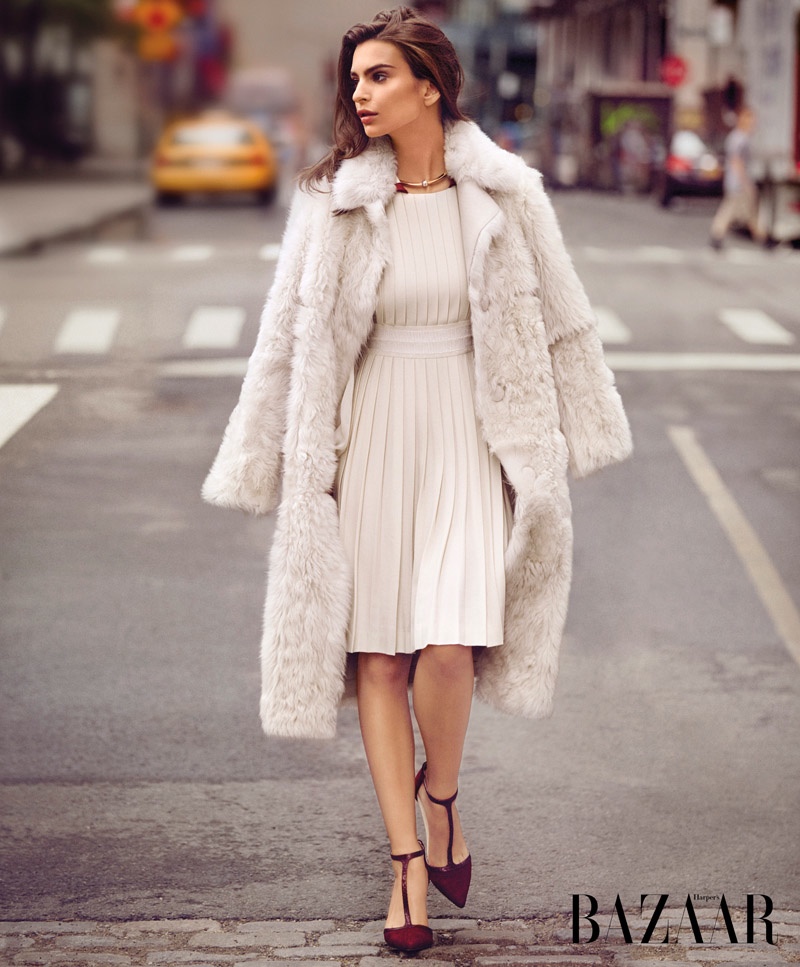 The model poses in the city streets wearing an all white look
