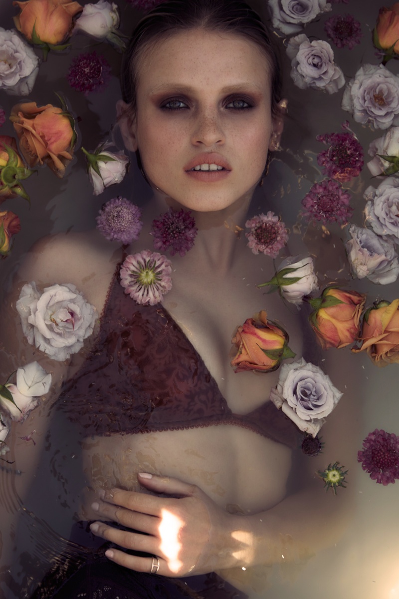 FLOWER GIRL: Anja takes a burgundy bra into the bath with this flower-filled image