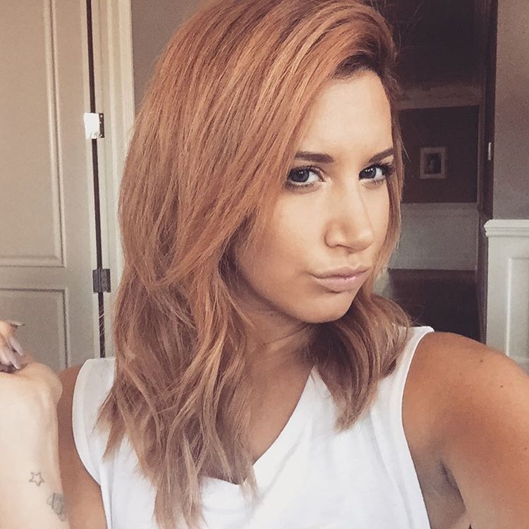 Actress Ashley Tisdale has gone from blonde to red with a new strawberry blonde hairstyle. Ashley showed off her waves in new Instagram photos.