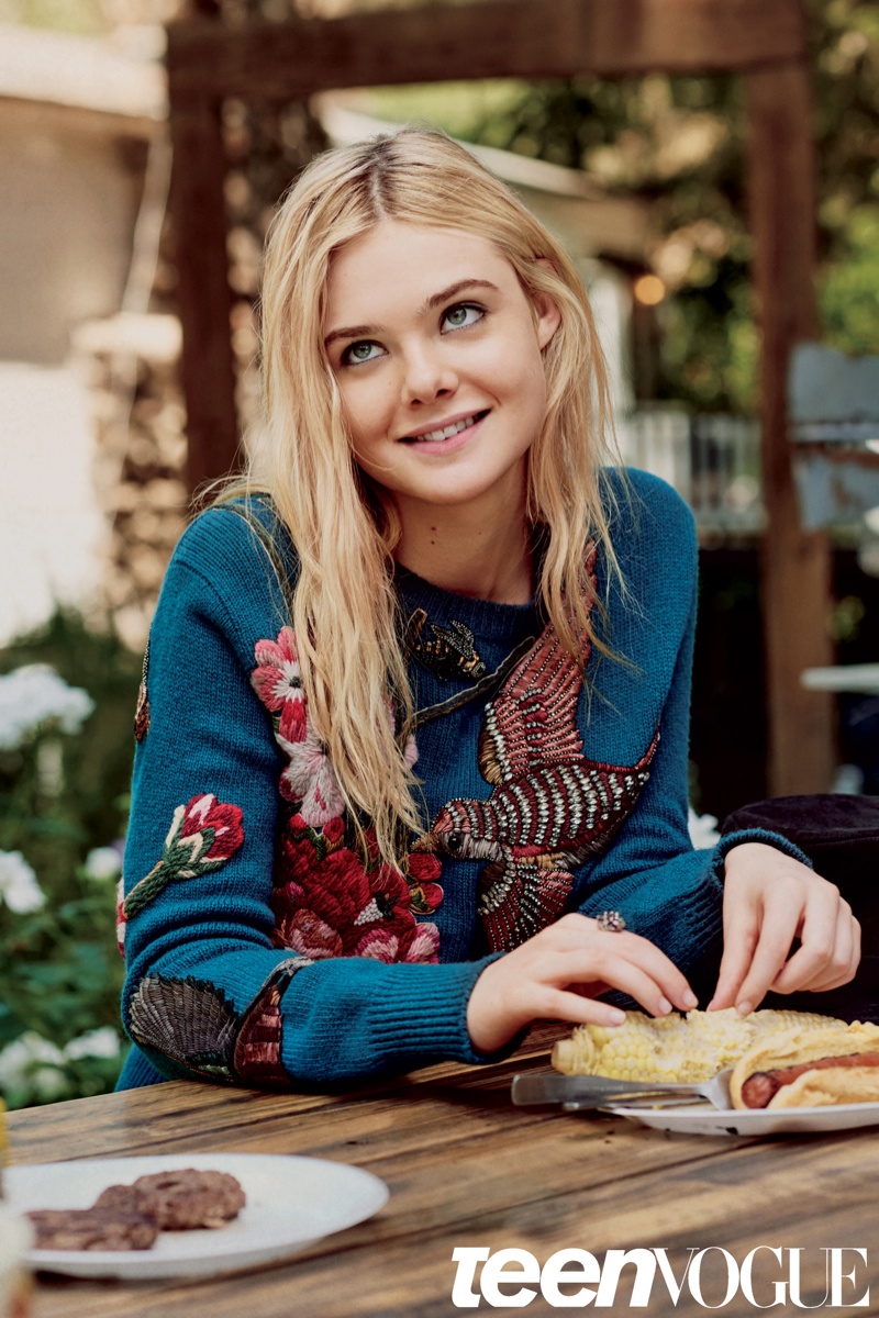 Elle is all smiles in a floral print sweater