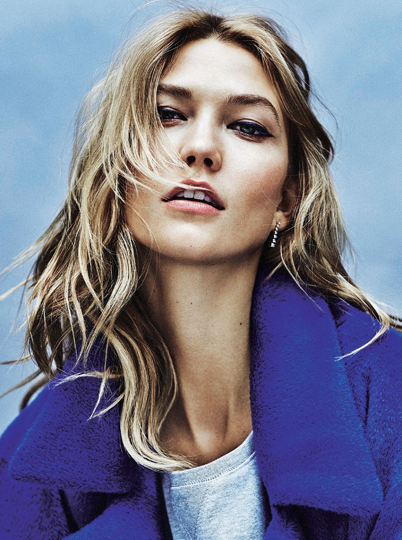 Karlie poses in a blue coat