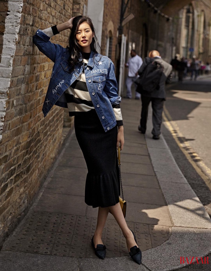 Liu models a denim jacket, striped shirt and mid-length skirt